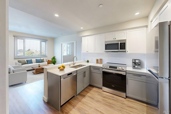 Kitchen with modern appliances and granite countertops in 888 4th Street Apartments, a luxury Greystar community