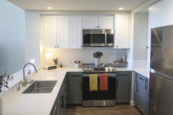 Modern kitchen with stainless steel appliances at 888 4th Street Apartments, a Greystar luxury property