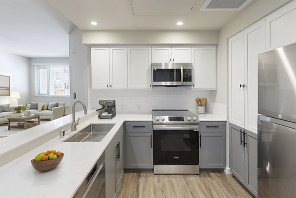 Modern kitchen with stainless steel appliances at 888 4th Street Apartments