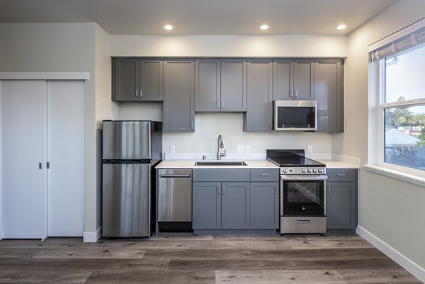 Modern kitchen with stainless steel appliances at 888 4th Street Apartments