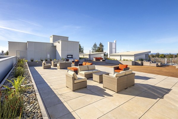 Spacious outdoor patio at 888 4th Street Apartments featuring modern seating and lush greenery, perfect for relaxation and social gatherings