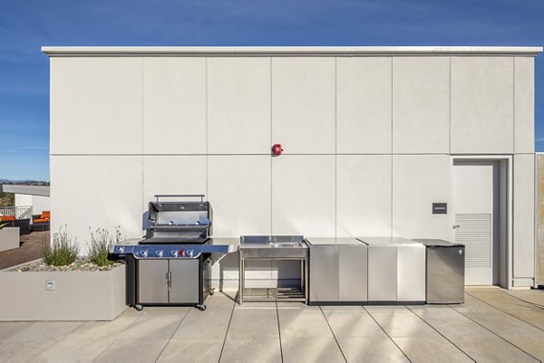 Outdoor grill area with modern setup at 888 4th Street Apartments, a luxury living community offering amenities for residents