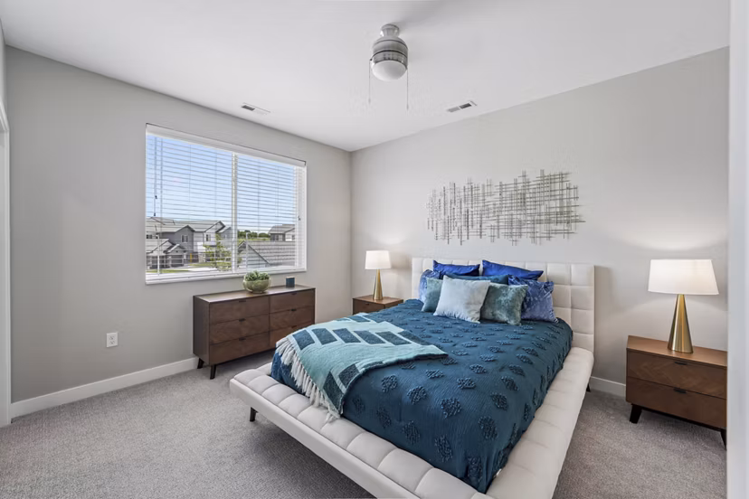 Modern bedroom with stylish furniture and large windows in Vestara 72 Apartments