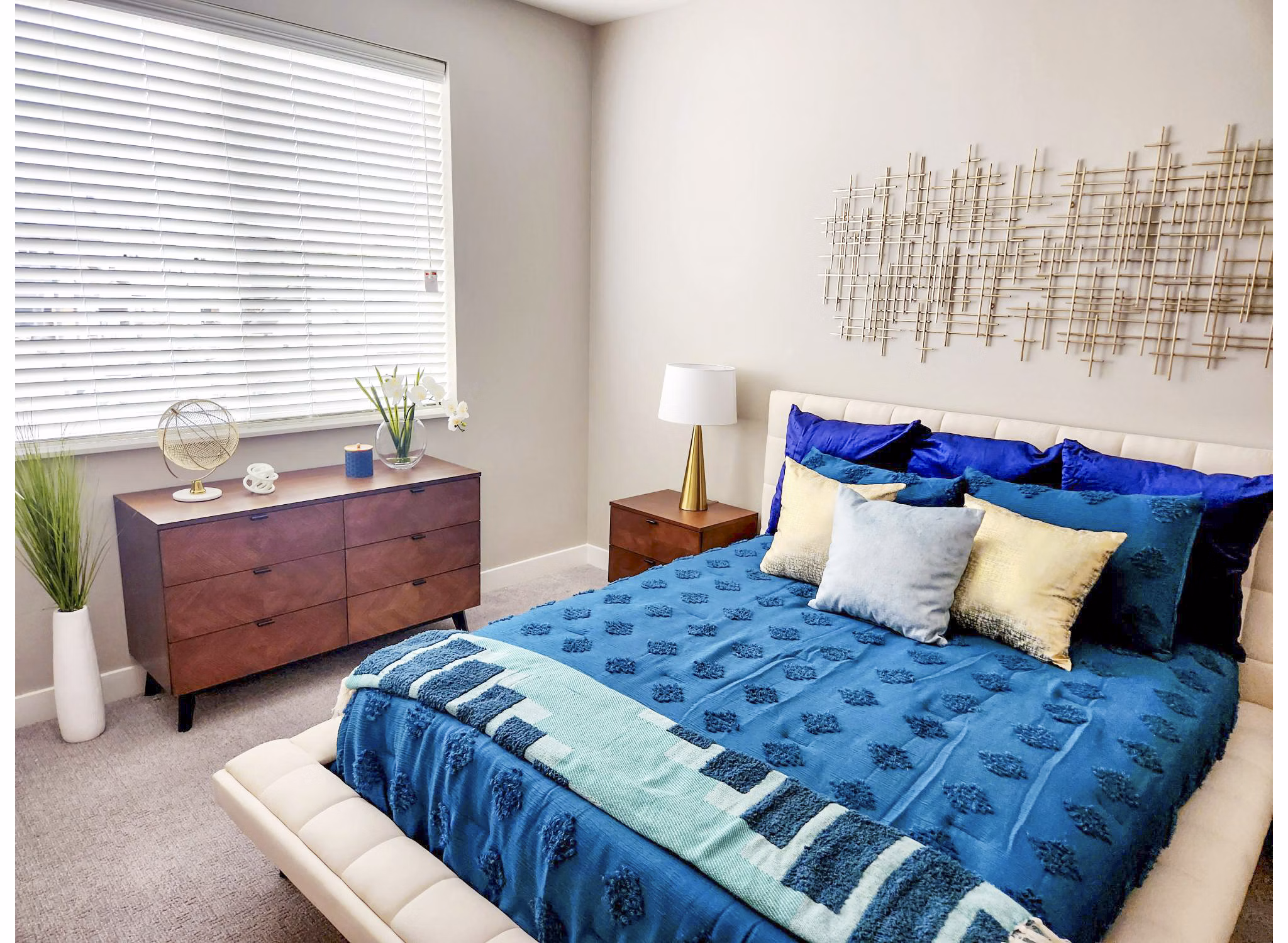 Modern bedroom with stylish furniture and large windows in Vestara 72 Apartments
