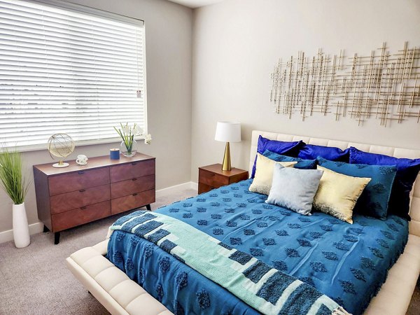 Modern bedroom with stylish furniture and large windows in Vestara 72 Apartments