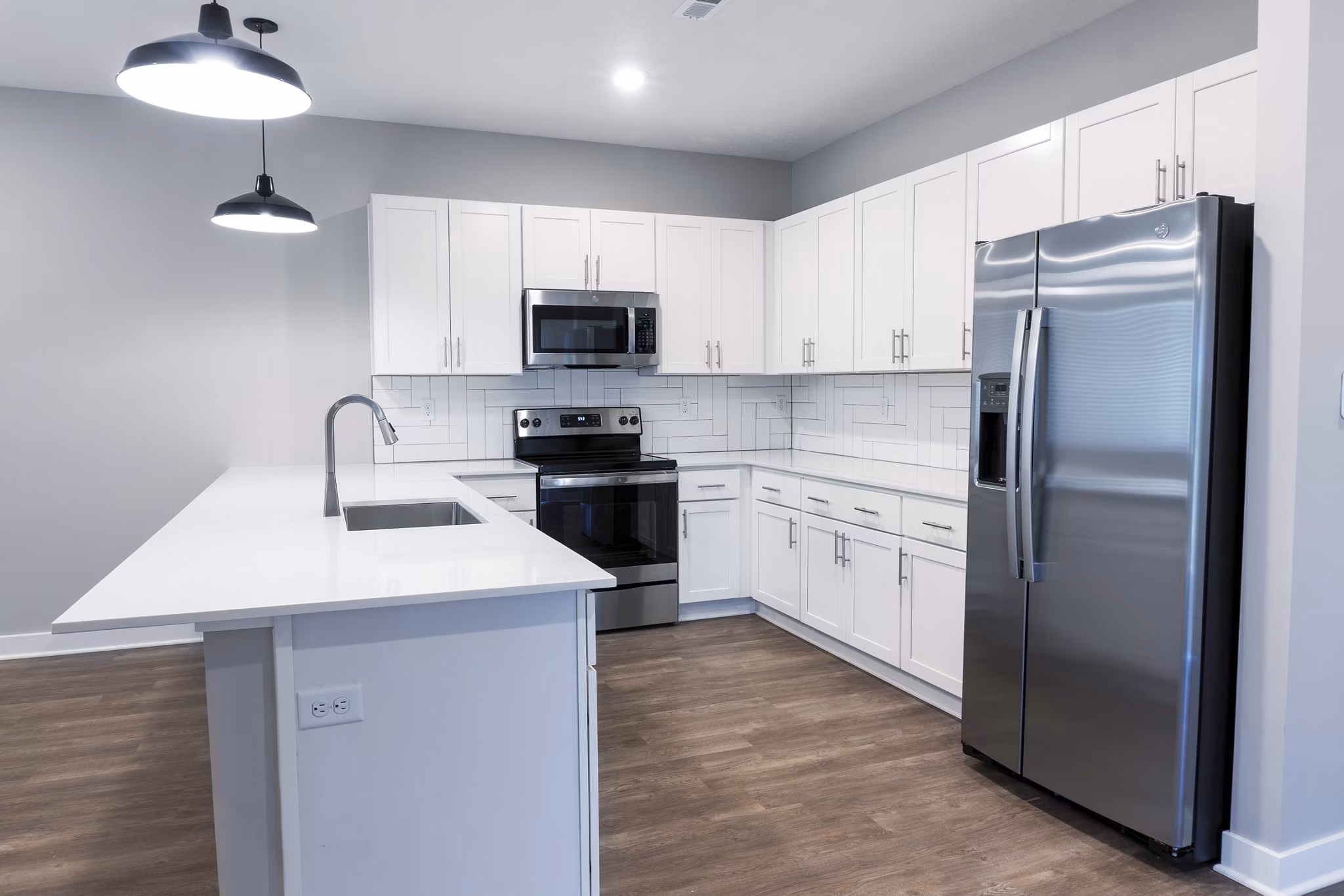 Modern kitchen with sleek cabinetry and stainless steel appliances at Vestara 72 Apartments