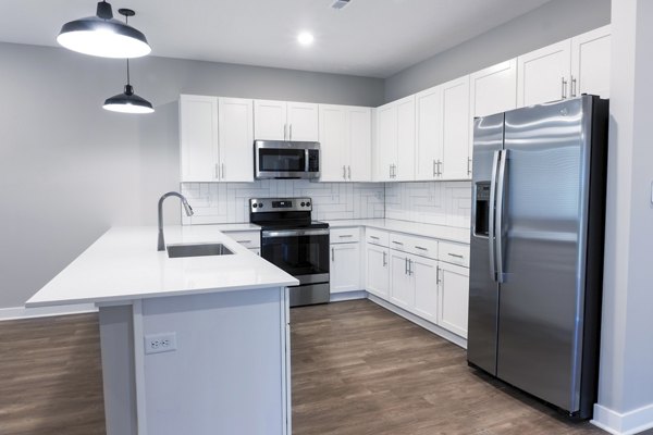 Modern kitchen with sleek cabinetry and stainless steel appliances at Vestara 72 Apartments