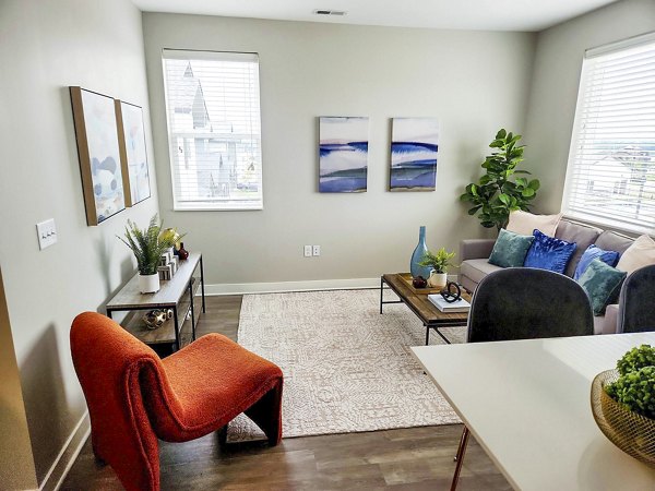 Modern living room with sleek furniture and large windows at Vestara 72 Apartments