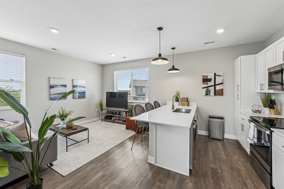 Modern living room with sleek furniture and large windows at Vestara 72 Apartments
