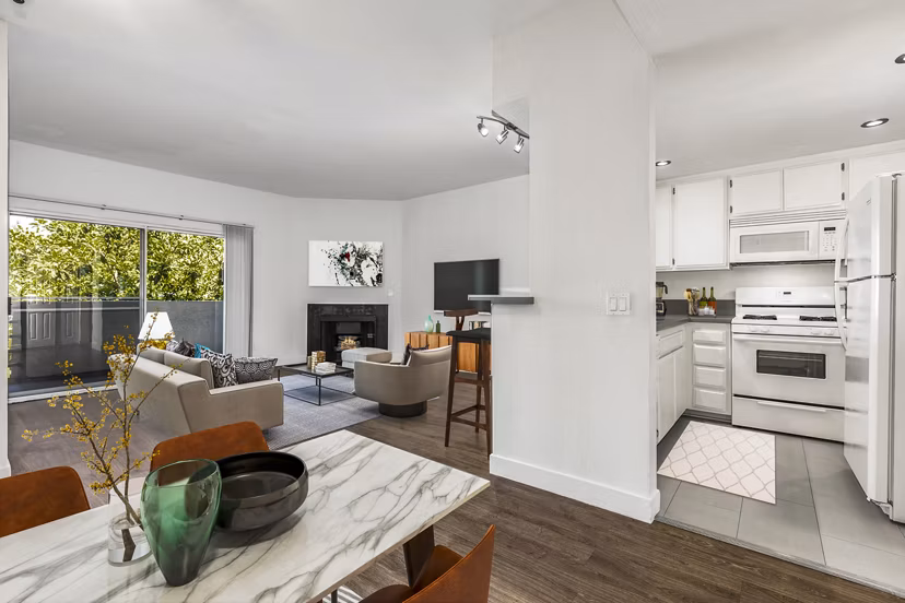 Dining room and kitchen featuring modern appliances at Cahuenga Heights Apartments