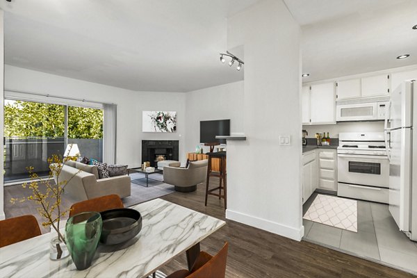Dining room and kitchen featuring modern appliances at Cahuenga Heights Apartments