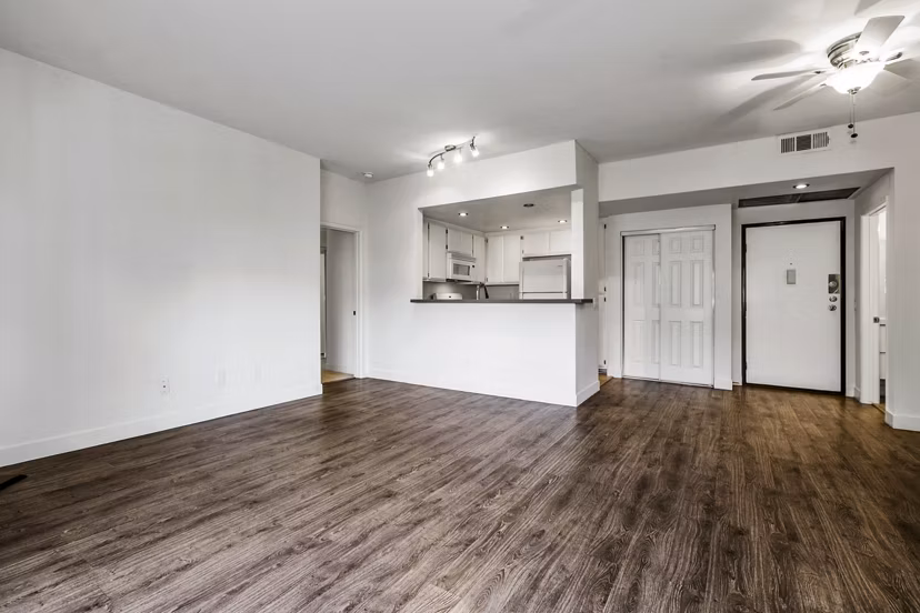 Living room with modern furnishings and large windows at Cahuenga Heights Apartments in Los Angeles