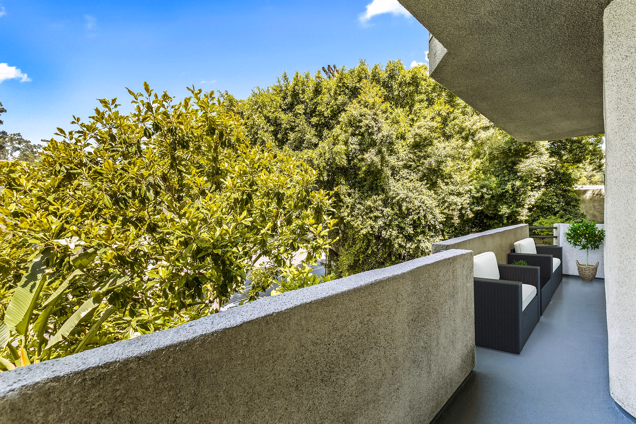 Patio with modern furniture and city views at Cahuenga Heights Apartments