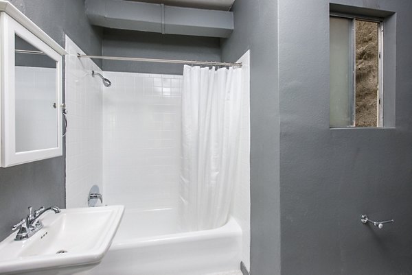 Elegant bathroom featuring marble countertops and modern fixtures at Del Mor Apartments