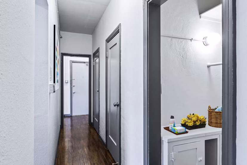 Hallway bathroom with sleek modern fixtures at Del Mor Apartments