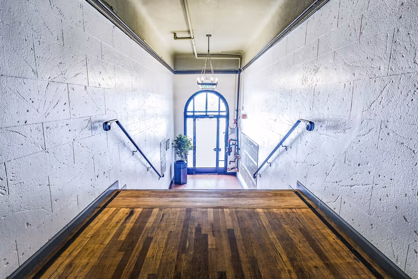 Clubhouse hallway entrance showcasing elegant design and modern lighting at Del Mor Apartments in a Greystar community