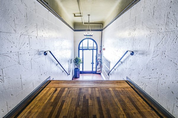 Clubhouse hallway entrance showcasing elegant design and modern lighting at Del Mor Apartments in a Greystar community