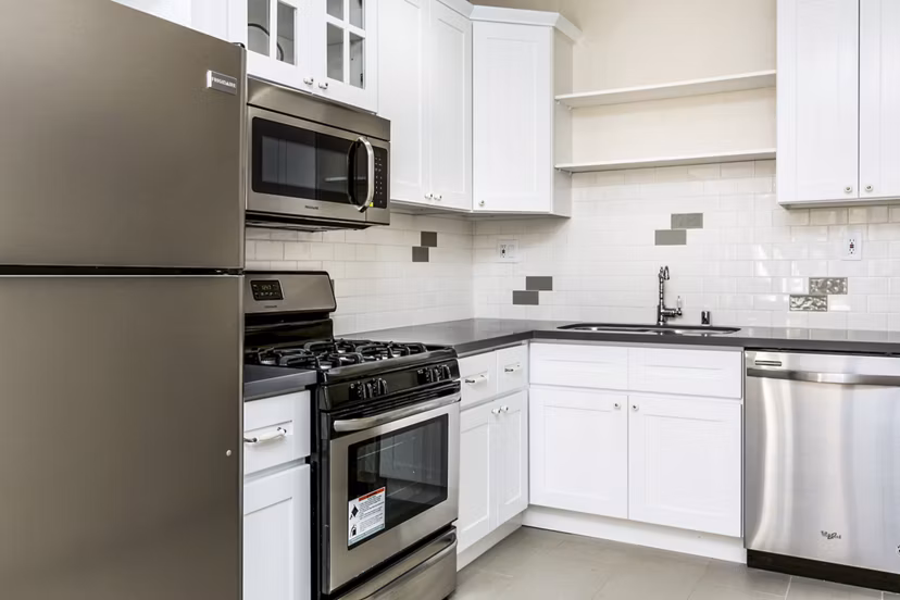 Modern kitchen with stainless steel appliances at Del Mor Apartments