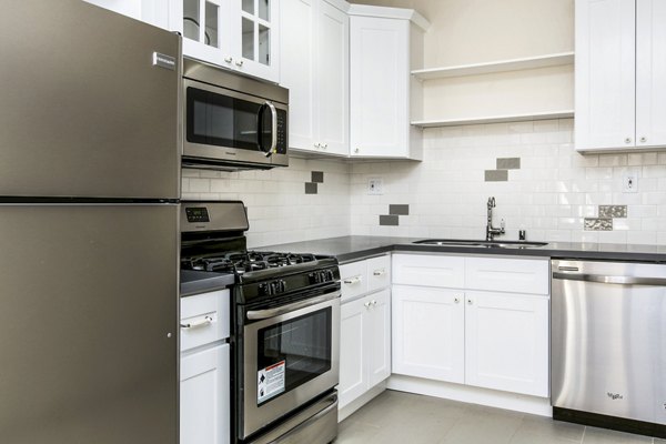 Modern kitchen with stainless steel appliances at Del Mor Apartments