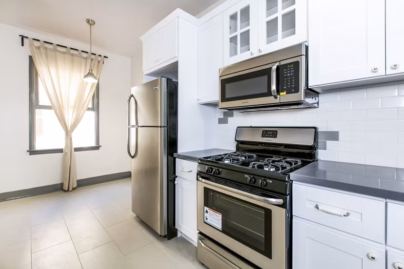 Sleek kitchen with stainless steel appliances at Del Mor Apartments