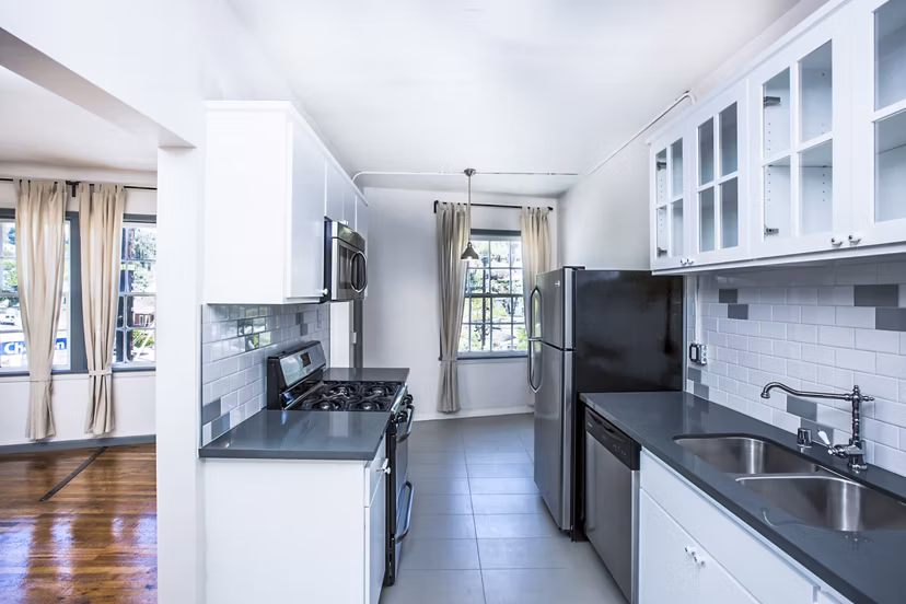 Modern kitchen featuring high-end appliances and sleek cabinetry at Del Mor Apartments