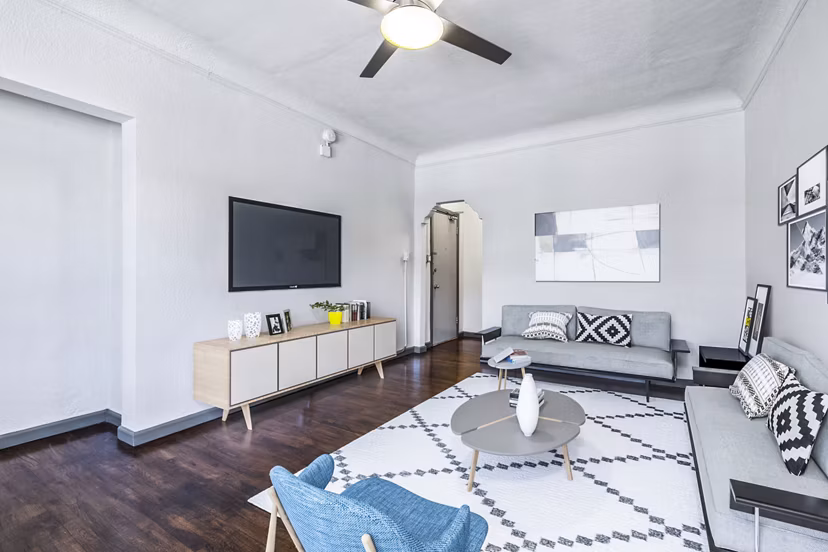 Stylish living room with contemporary decor and natural light in Del Mor Apartments