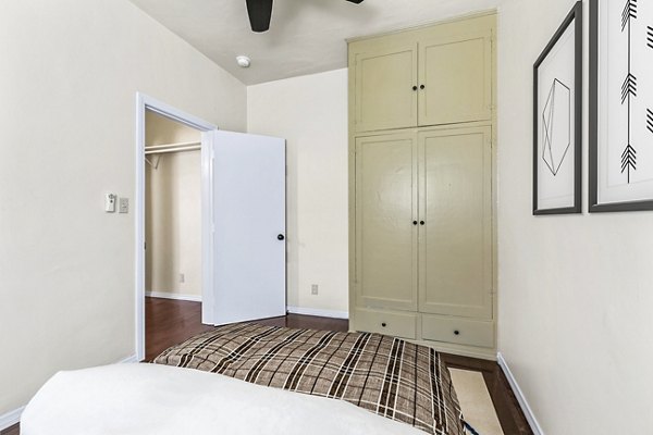 Cozy bedroom featuring modern dÃ©cor and large windows at Delta Apartments