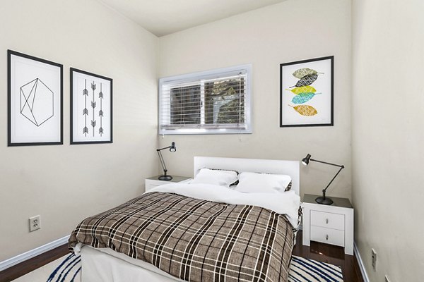 Bedroom featuring modern furnishings at Delta Apartments in Seattle