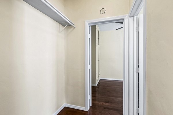 Organized bedroom closet with ample storage space in Delta Apartments