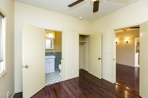 Cozy bedroom with modern furnishings at Delta Apartments featuring ample natural light