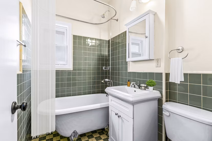 Modern bathroom featuring sleek fixtures and marble countertops in Delta Apartments