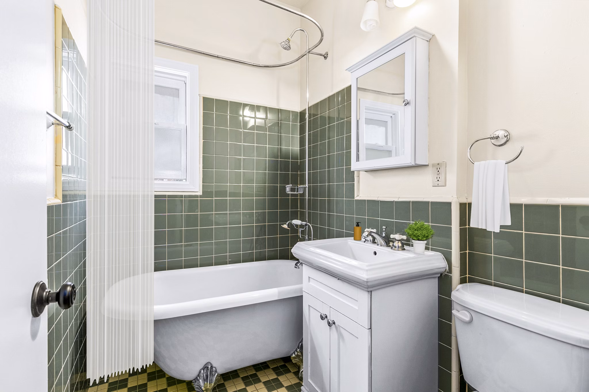 Modern bathroom featuring sleek fixtures and marble countertops in Delta Apartments