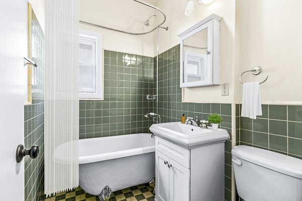 Modern bathroom featuring sleek fixtures and marble countertops in Delta Apartments