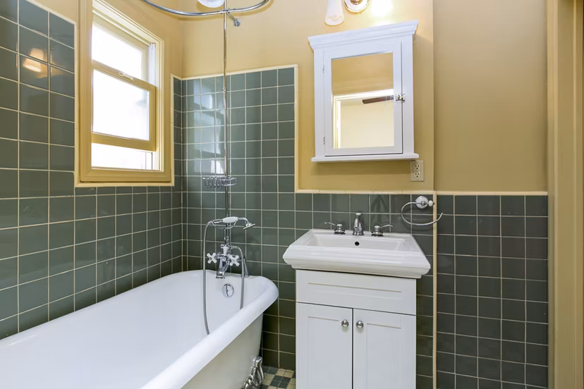 Spacious bathroom with sleek modern fixtures in Delta Apartments, luxury living by Greystar