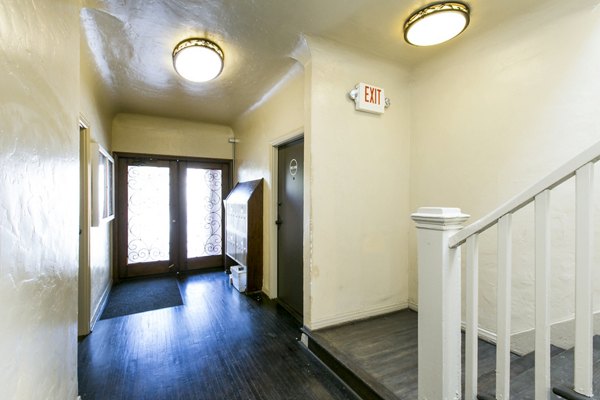 Delta Apartments: Elegant building entry with stairway, offering luxury living in a prime location