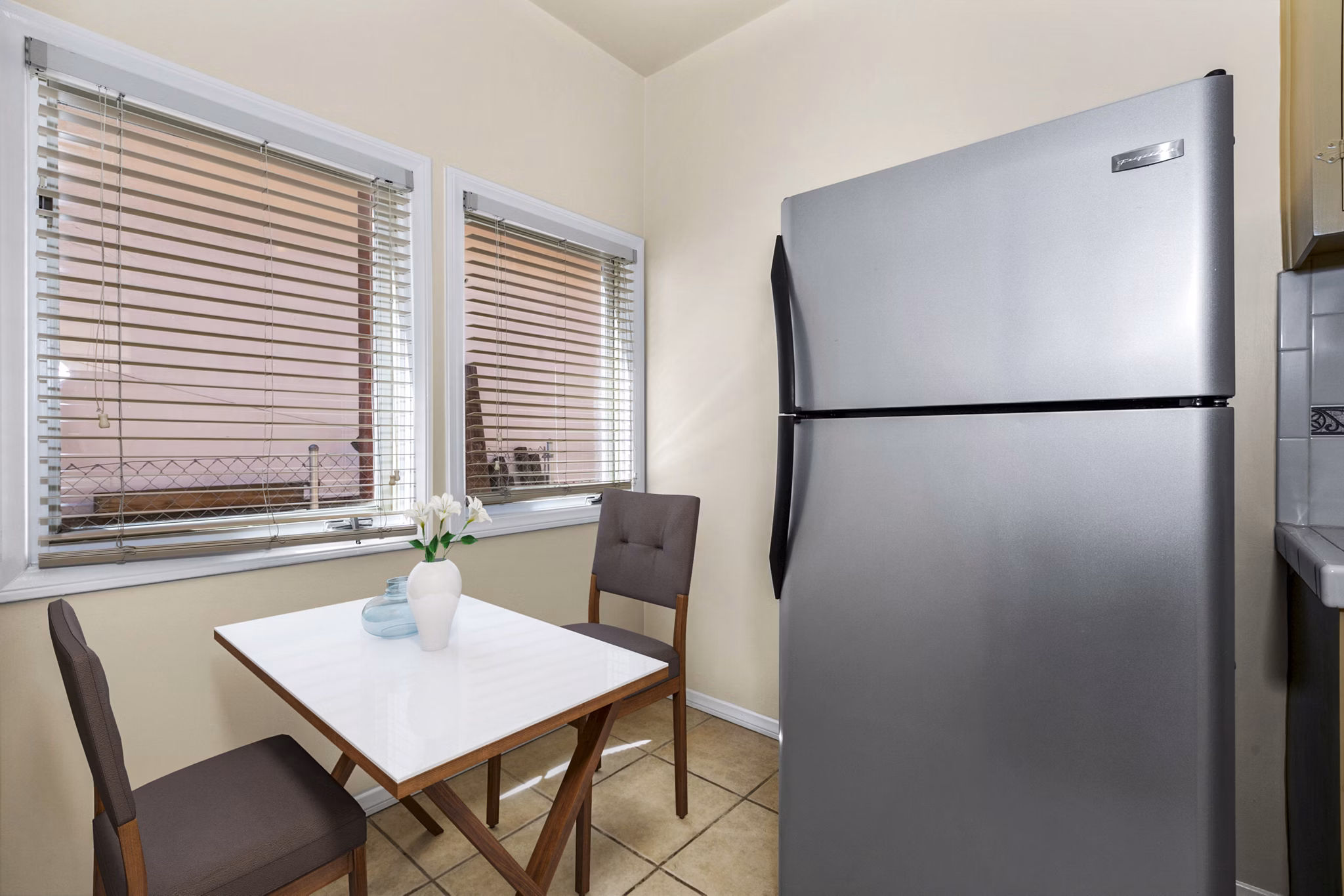 Modern dining room with open kitchen layout in Delta Apartments