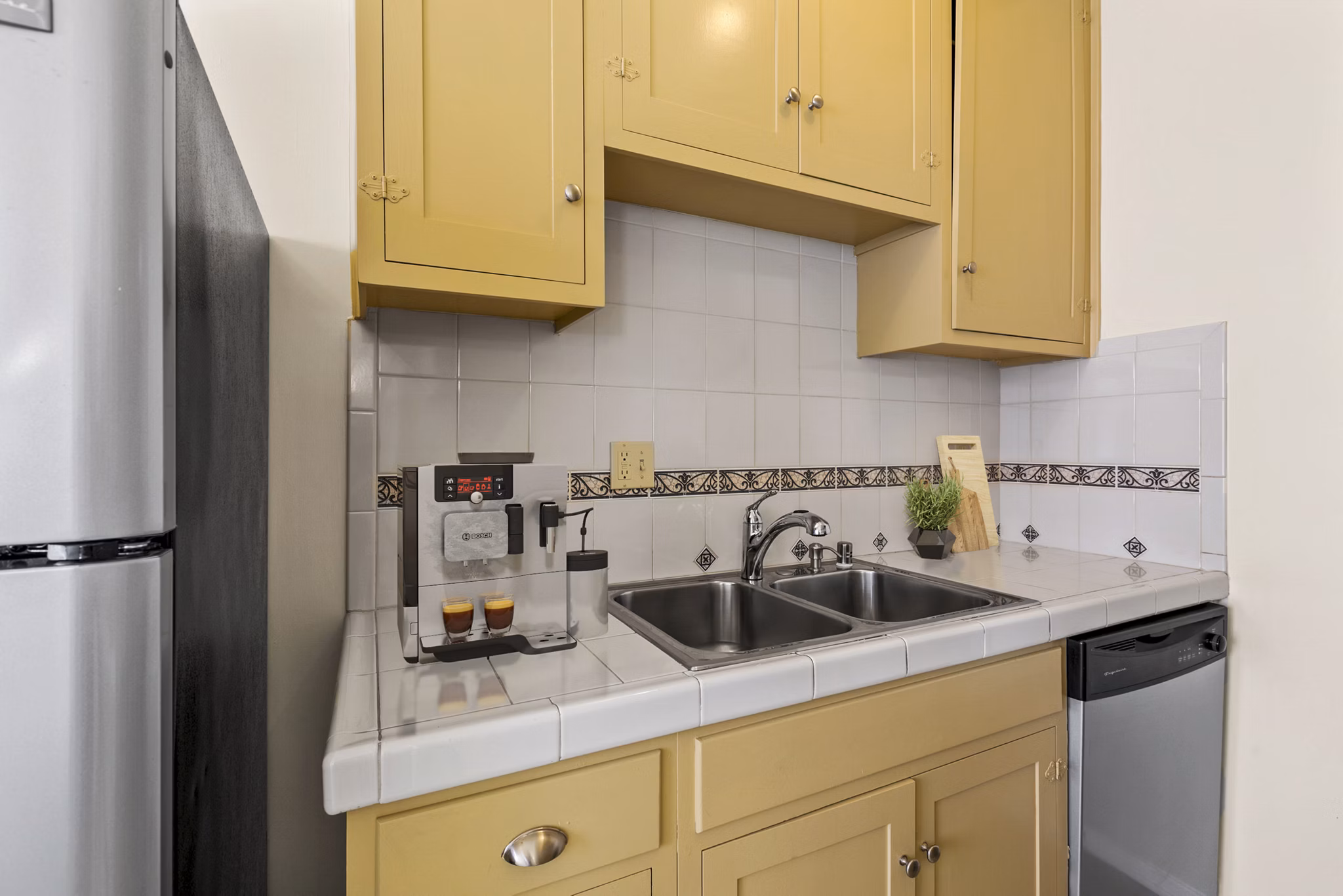 Modern kitchen with stainless steel appliances at Delta Apartments