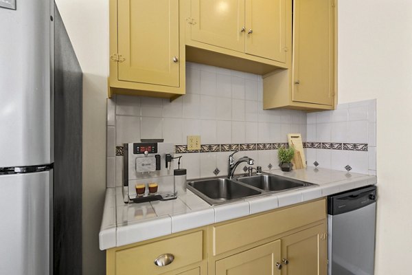 Modern kitchen with stainless steel appliances at Delta Apartments