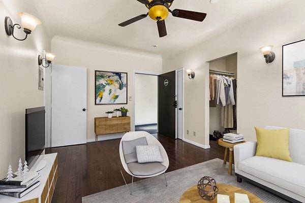 Living room featuring modern decor and ample natural light at Delta Apartments