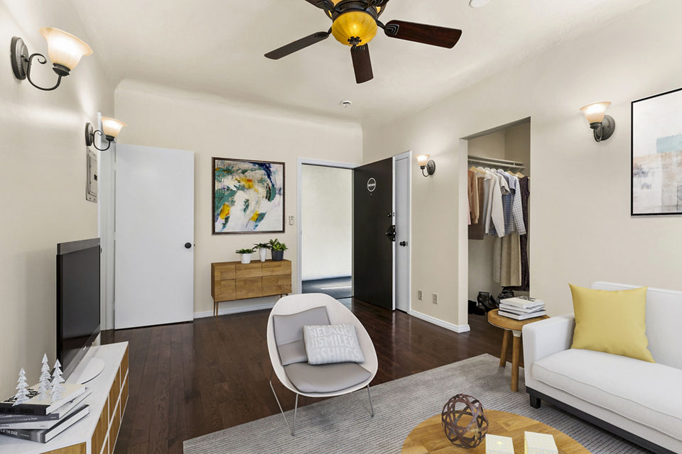 Living room featuring modern decor and ample natural light at Delta Apartments