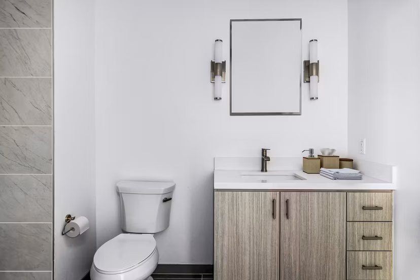 Modern bathroom with sleek fixtures and marble countertops in Edendale Crossing Apartments