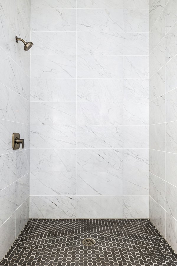 Bathroom featuring modern fixtures and marble countertops in Edendale Crossing Apartments