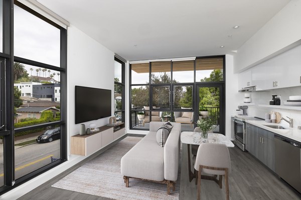 Studio apartment interior featuring modern living room, dining area, and kitchen at Edendale Crossing Apartments