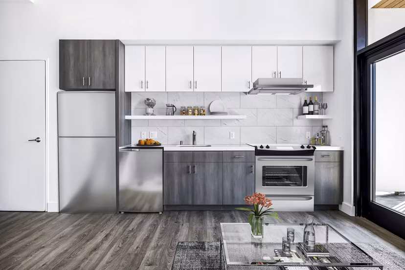 Modern kitchen featuring stainless steel appliances and granite countertops at Edendale Crossing Apartments