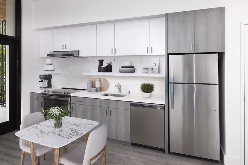 Dining and kitchen area with modern appliances at Edendale Crossing Apartments