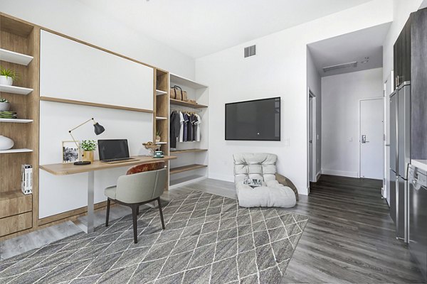 Studio living room with versatile home office at Edendale Crossing Apartments, showcasing modern luxury apartment design