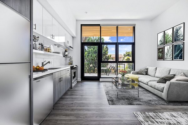 Modern living room with sleek furnishings and natural light at Edendale Crossing Apartments