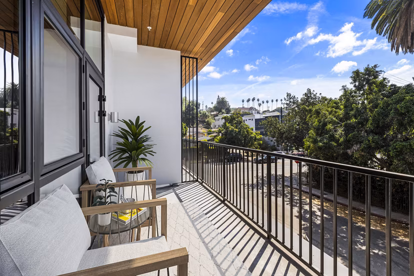 Relaxing patio balcony view at Edendale Crossing Apartments with comfortable seating and lush greenery
