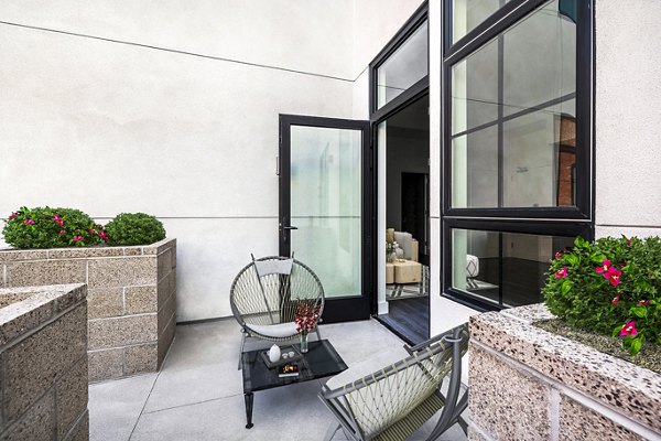 Outdoor patio with modern seating and greenery at Edendale Crossing Apartments offering luxury living