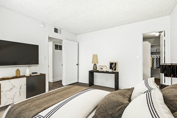 The Fulton Apartments: Cozy bedroom with walk-in closet offering comfort and style in downtown living